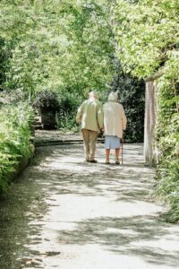 Retired couple walking together, considering a move into a NSW retirement village